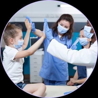 Child high-fiving a masked therapist during an ABA therapy session