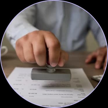 Hand stamping an approval on a document