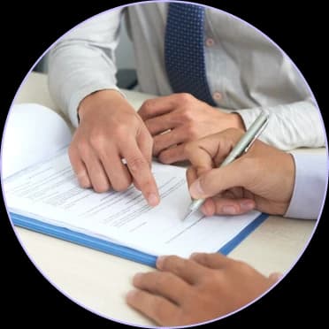 Two people reviewing and signing a claims document