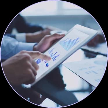 Hands reviewing revenue charts on a tablet
