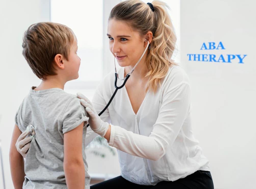 Clinician using a stethoscope on a child in front of an ABA Therapy sign