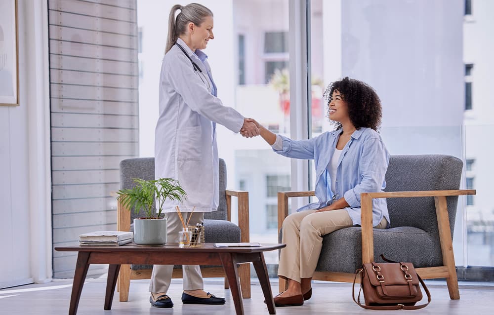 Nurse practitioner shaking hands with a patient