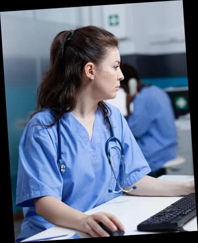 Nurse reviewing patient records on a computer