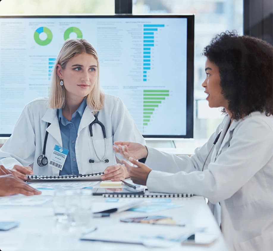 Physicians reviewing operational and financial dashboards together