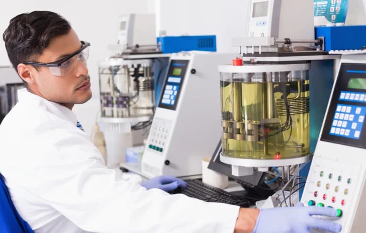 Lab technician operating laboratory testing instruments