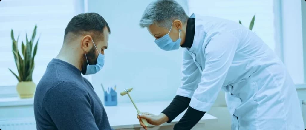 Orthopedic clinician performing a reflex test on a patient