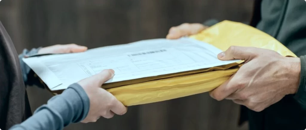Hands exchanging a medical records envelope