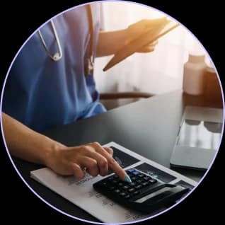Clinician using a calculator at a desk with a tablet