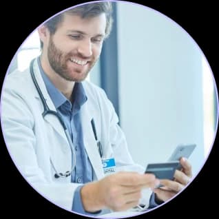 Smiling orthopedic physician checking a card on his phone
