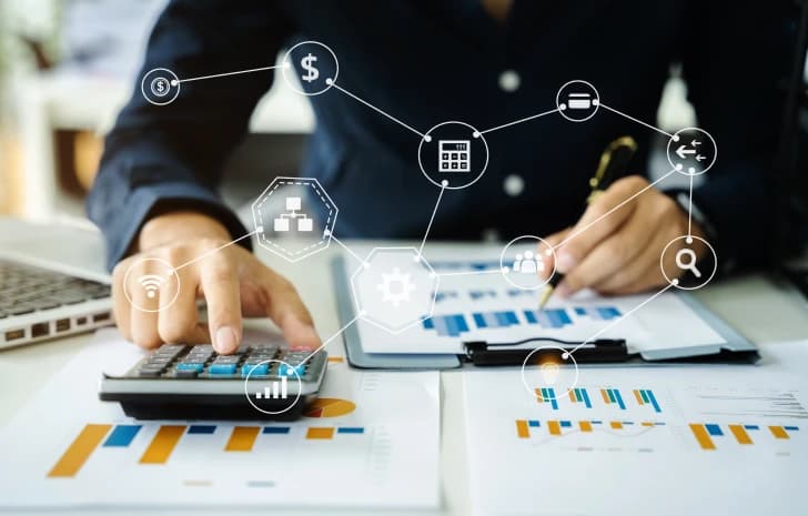 Accountant calculating financial data surrounded by revenue cycle icons