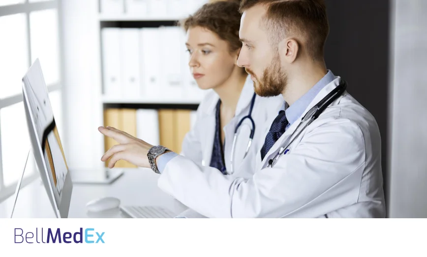 Medical coders reviewing a chart on screen together
